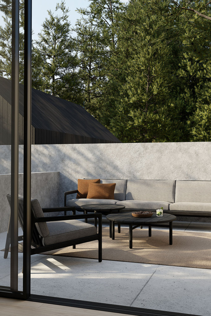 Outdoor patio with modern furniture and greenery