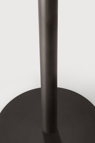 Black metal table base on a white background