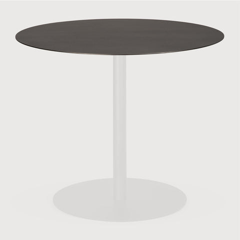 Round table with dark top and white base on a light gray background