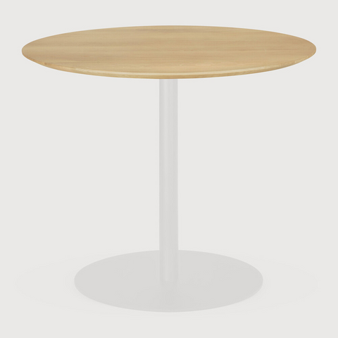 Round wooden table with a white base on a light gray background