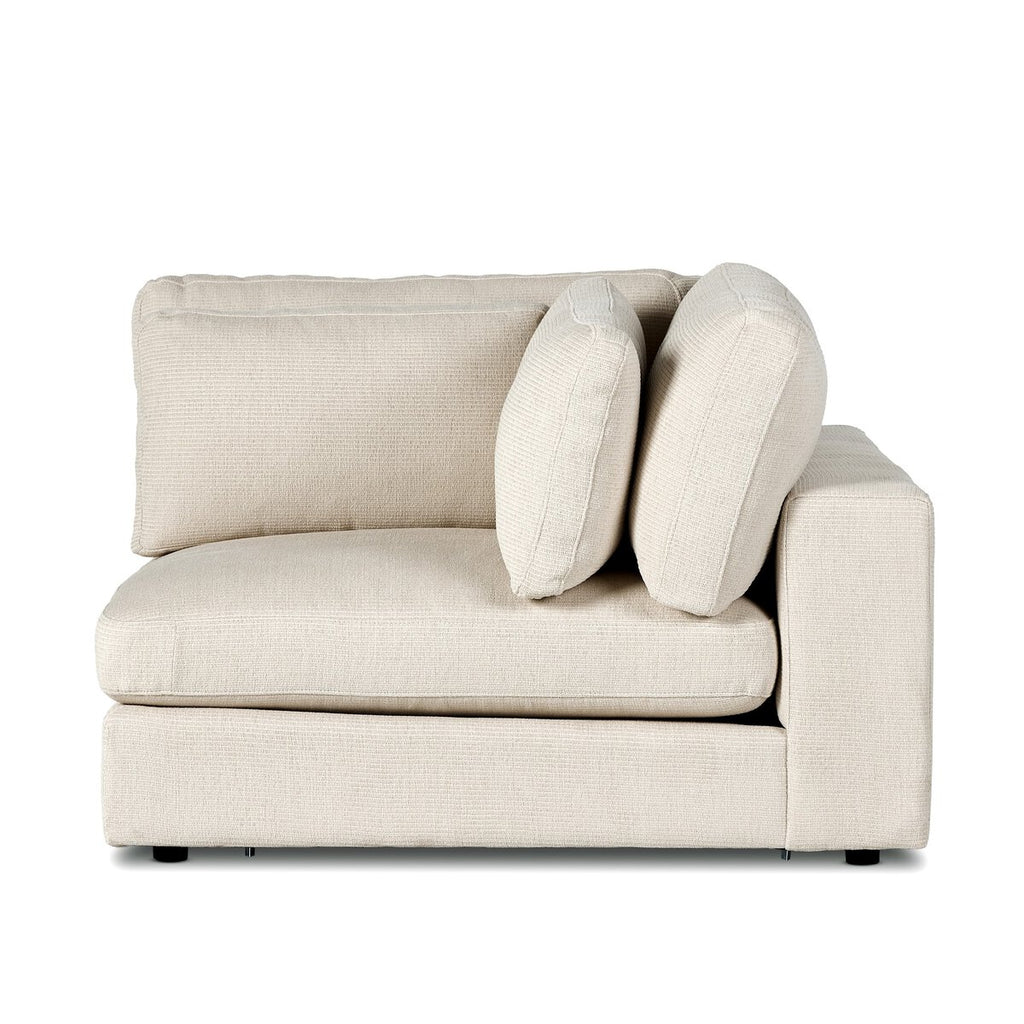 Beige corner sofa with cushions on a white background