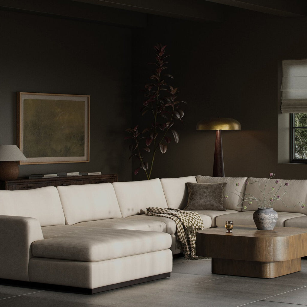 Modern living room with a beige sectional sofa, wooden coffee table, and decorative elements.