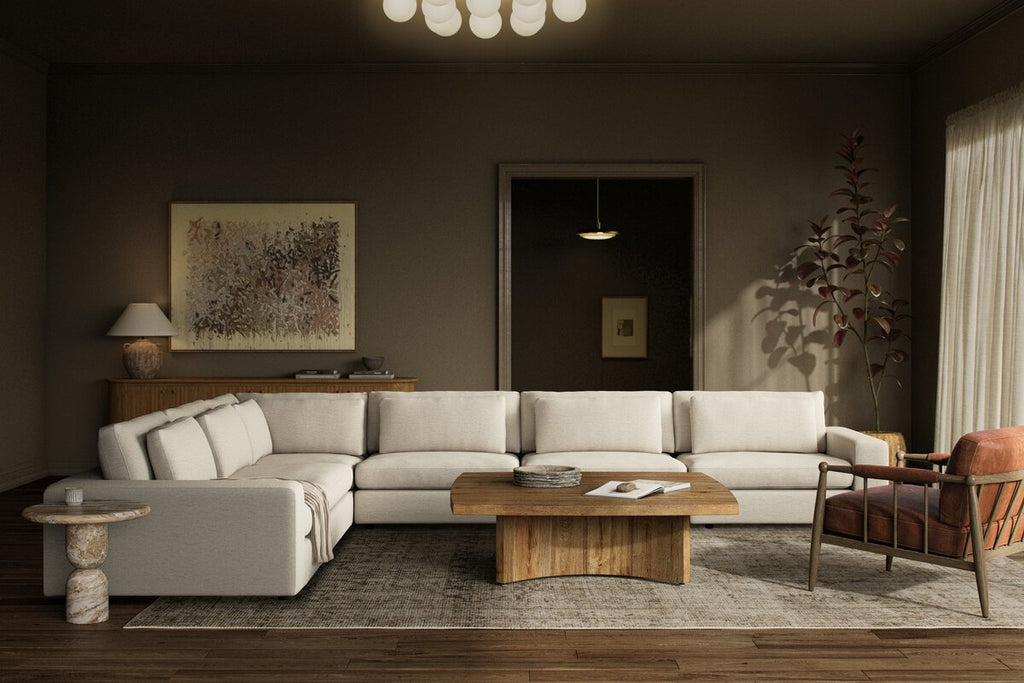 Modern living room with a sectional sofa, coffee table, and decorative items.