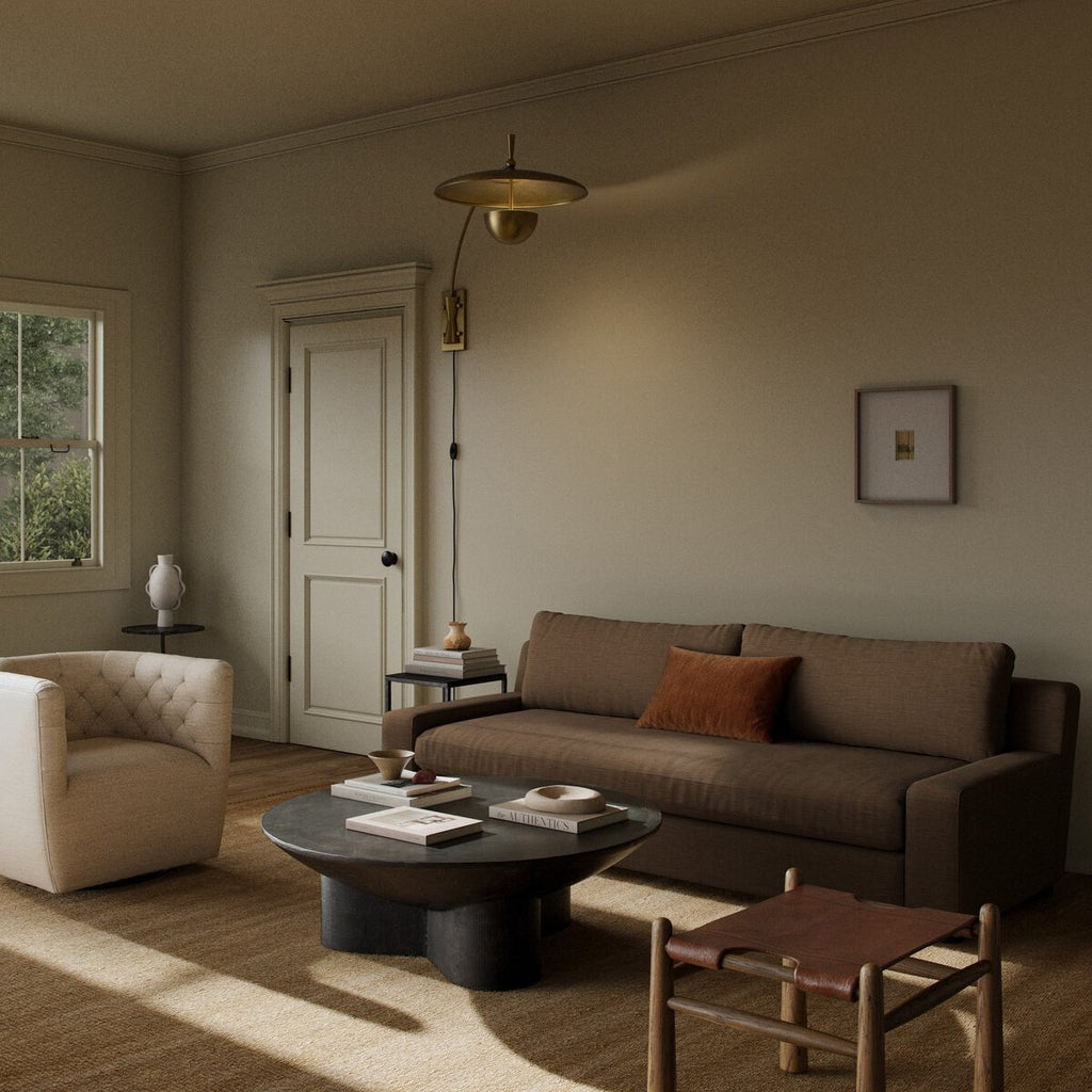Cozy living room with a brown sofa, armchair, and coffee table.