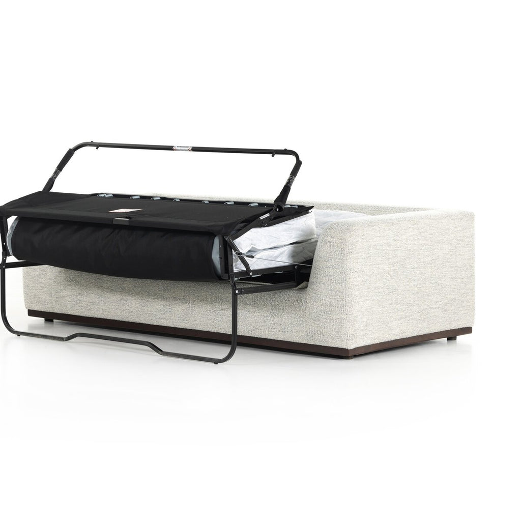 Modern sofa bed with black frame and beige cushion on a white background