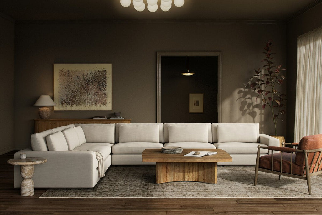 Modern living room with a sectional sofa, coffee table, and decorative items.