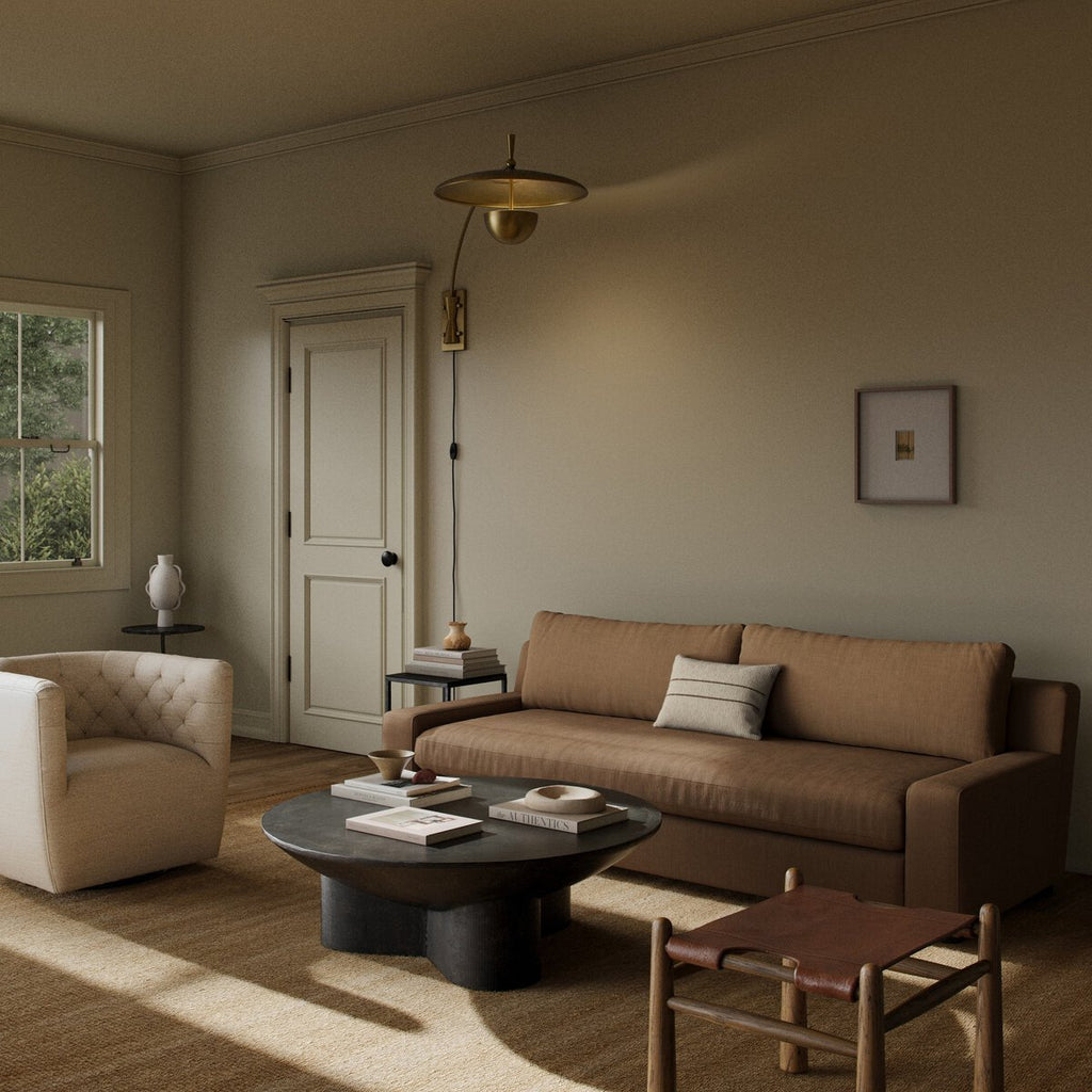 Cozy living room with brown sofa, armchair, and coffee table.