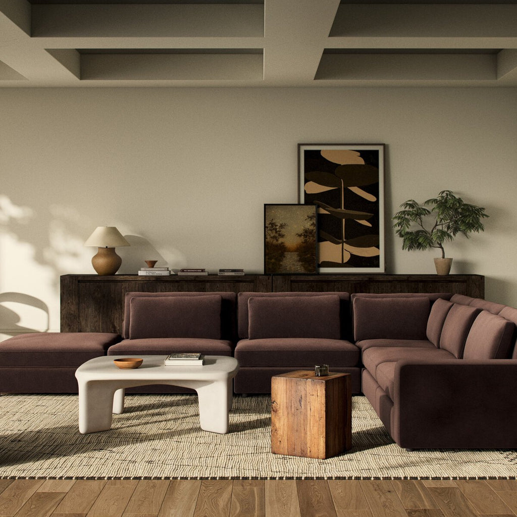 Modern living room with a brown sectional sofa, coffee table, and decorative items.