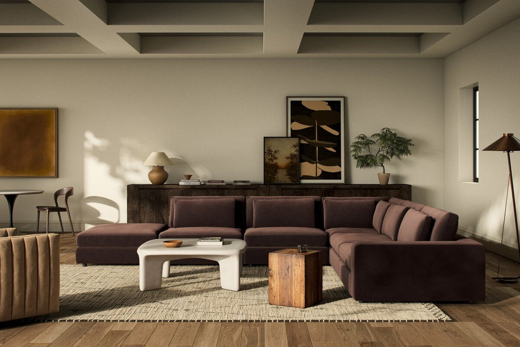 Modern living room with a brown sectional sofa, coffee table, and decorative items.