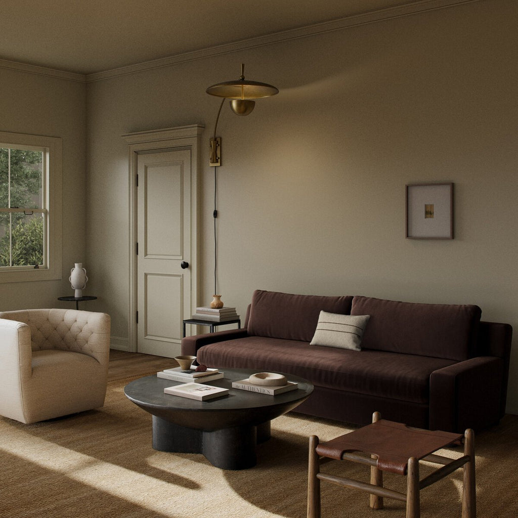 Cozy living room with a brown sofa, beige armchair, and round coffee table.