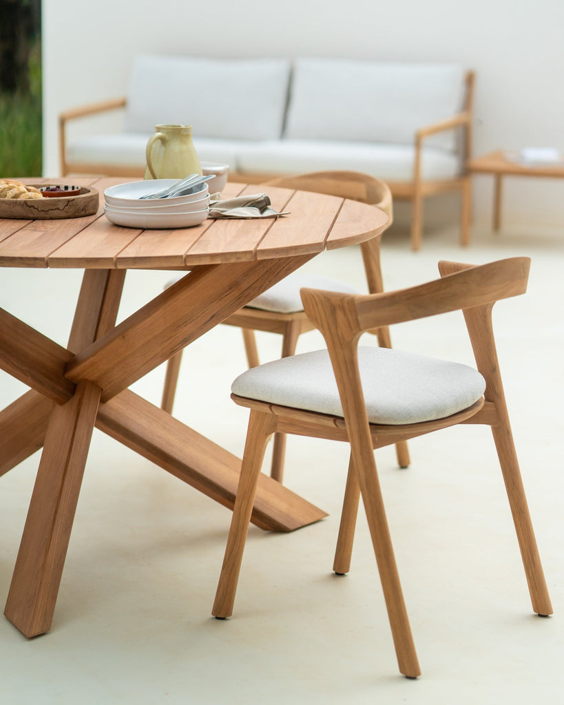 Wooden dining table with chairs in an outdoor setting