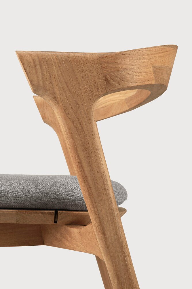 Wooden chair with a gray cushion on a white background