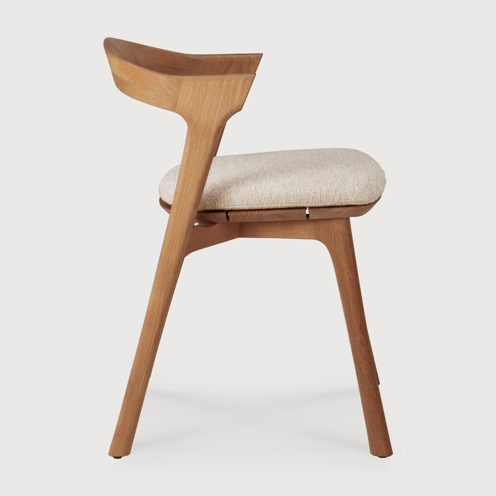 Wooden chair with a beige cushion on a white background