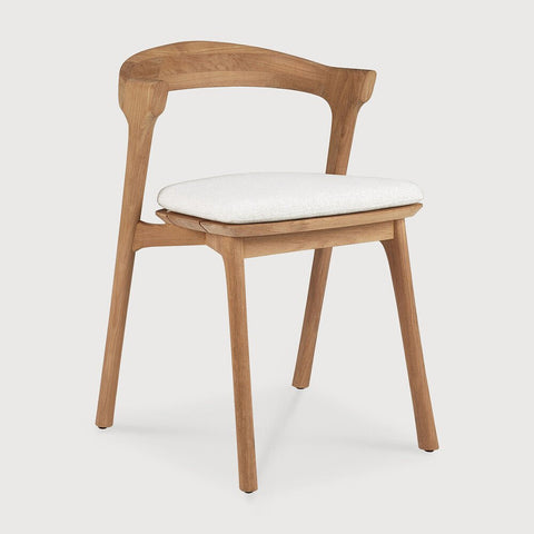 Wooden chair with a white cushion on a light gray background