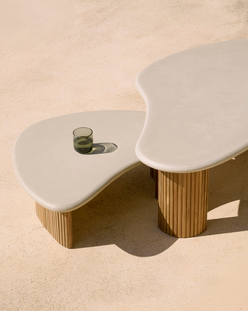 Modern coffee table with wavy design on a beige surface