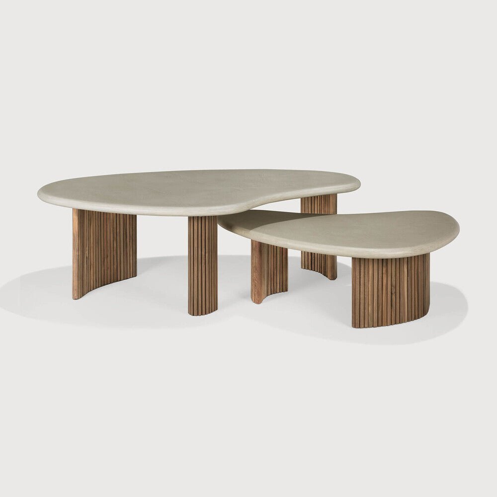 Modern coffee table with wooden legs and a light gray top on a white background