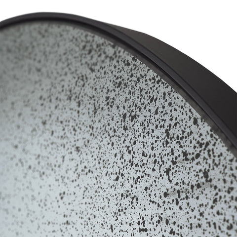 Arched gate wall mirror with distressed surface and sleek metal frame by Sage Interiors