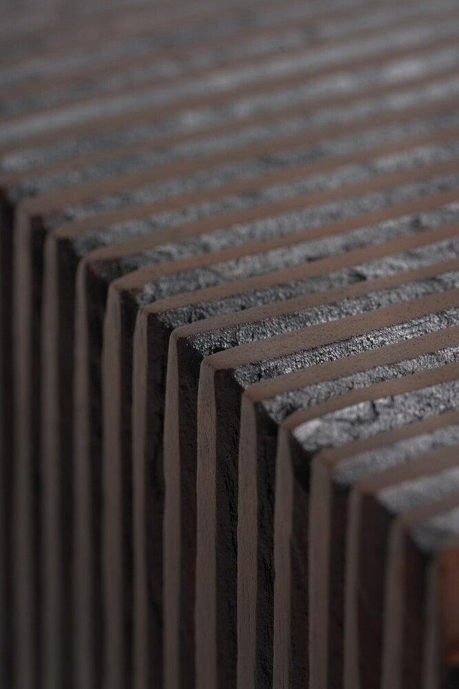Close-up of a textured metal surface with horizontal slats