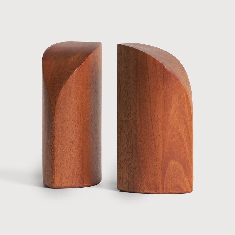Two wooden bookends on a white background