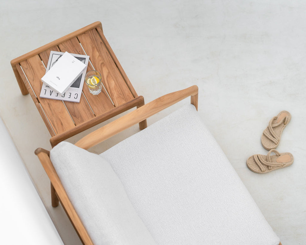 Wooden tray on a chair with a drink and newspaper, white background