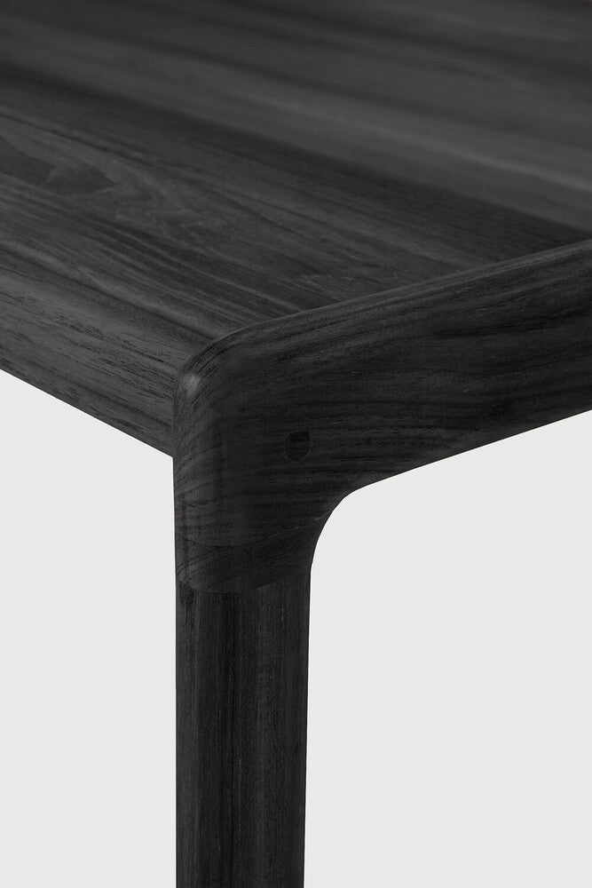 Close-up of a dark wooden table corner on a light gray background