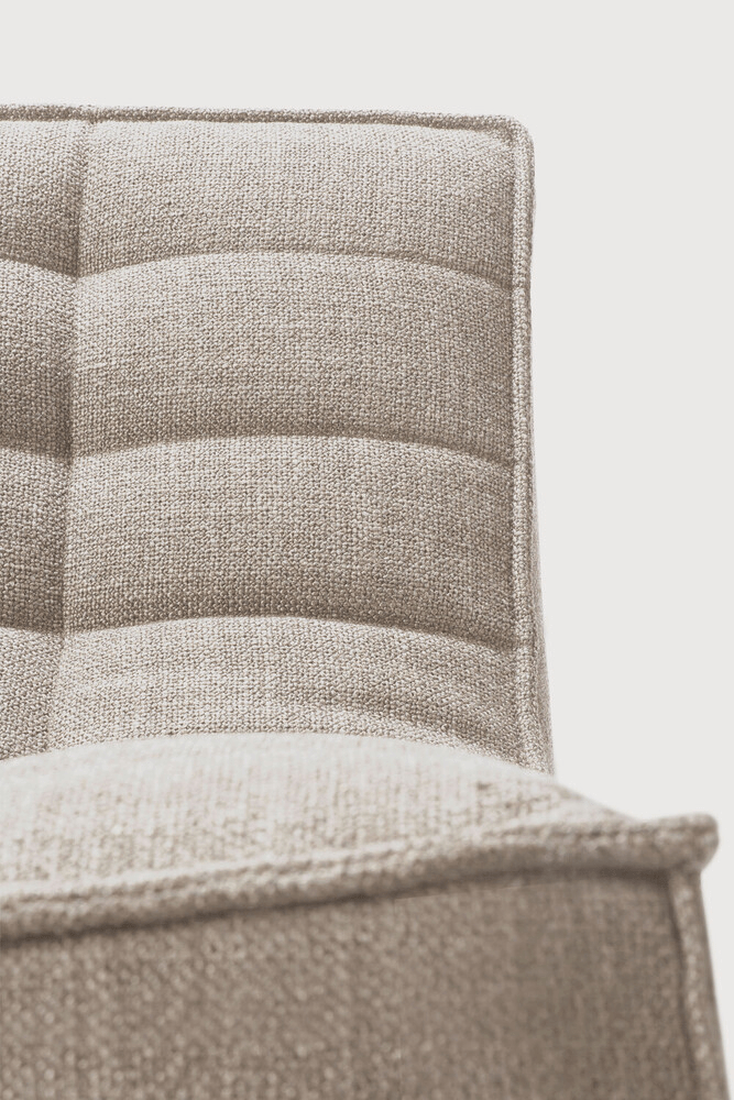 Close-up of a textured beige chair with a neutral background