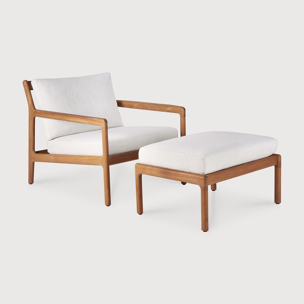 Wooden armchair and ottoman with white cushions on a light gray background