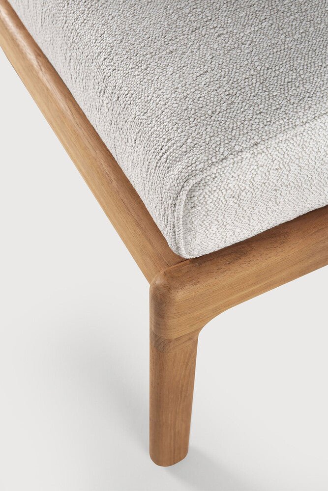 Close-up of a wooden chair with a textured cushion on a white background