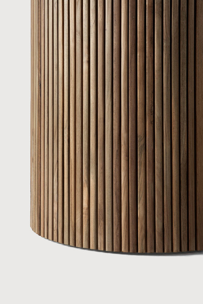 Wooden cylindrical object with a ribbed texture on a white background