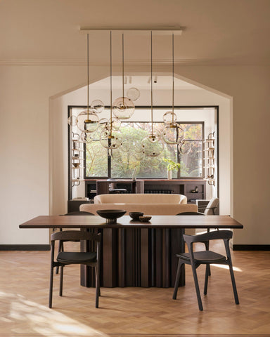 Solid Mahogany Sequence Dining Table with sculptural base and smooth dark wood finish from Sage Interiors